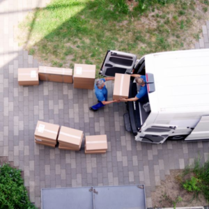 Movers loading boxes into a van, illustrating the process of sorting through items to toss before moving.