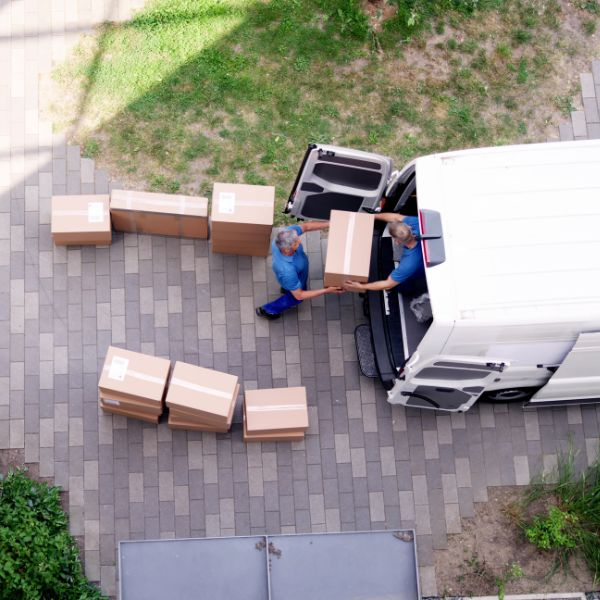 Movers loading boxes into a van, illustrating the process of sorting through items to toss before moving.